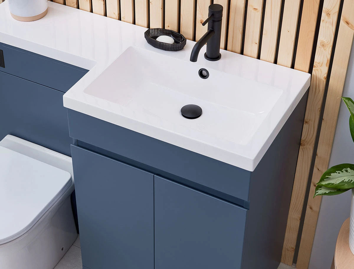 Bathroom setup with blue vanity unit, white sink, and black faucet.