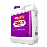 A white plastic jug of Sentinel X800 Cleaner with a prominent purple label and a purple cap, shown on a plain white background.