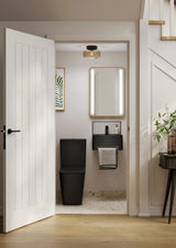 Bathroom interior with a toilet, sink, and mirror.