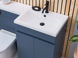 Bathroom setup with blue vanity unit, white sink, and black faucet.